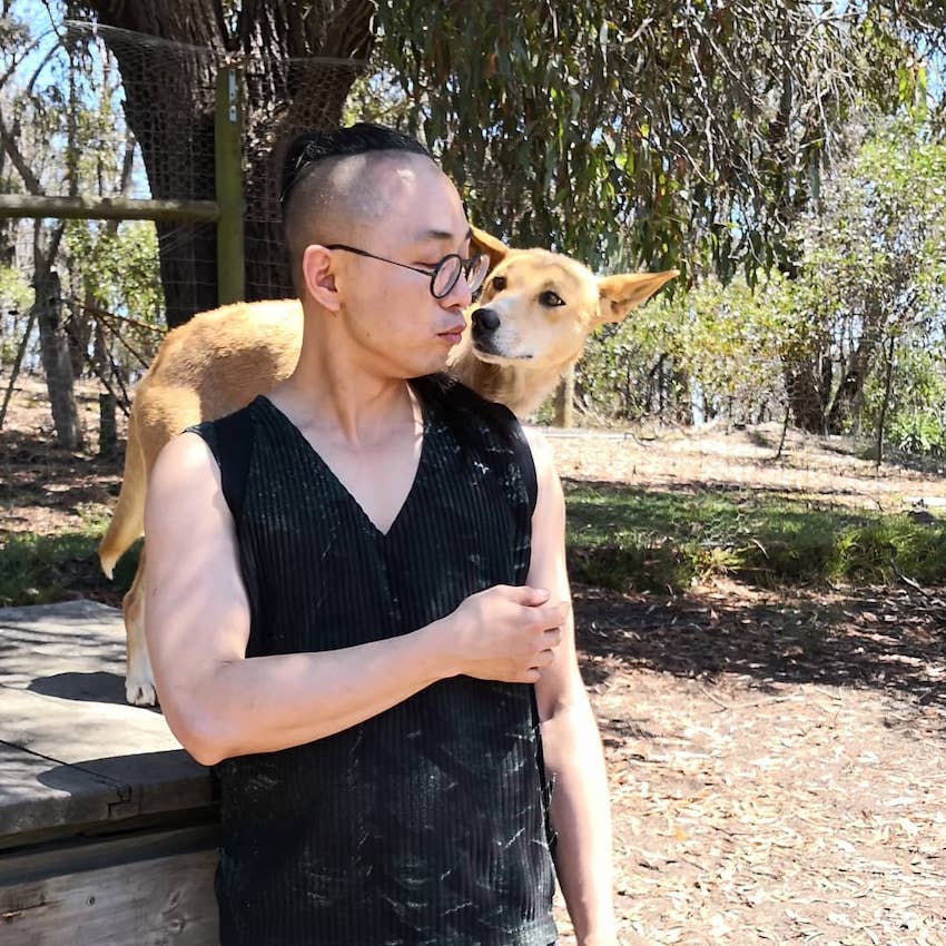 Ungendered clothing designer Vincent Li with a dingo - inspiration for his latest range